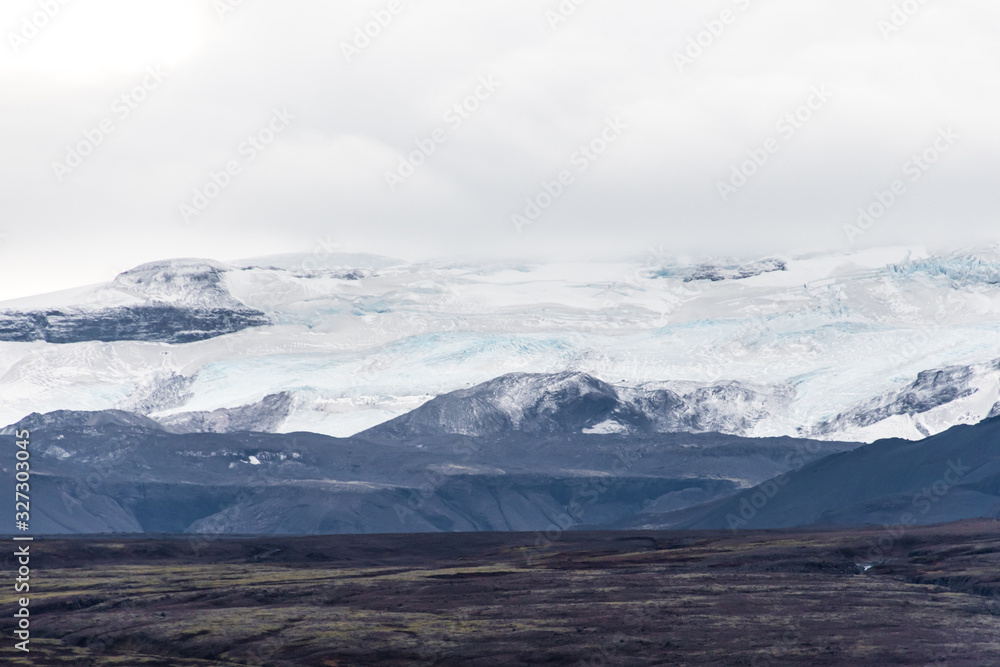 Langjoekull glacier behind of black lava field in Iceland