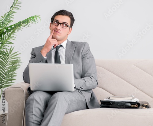 Businessman with laptop notebook sitting in sofa