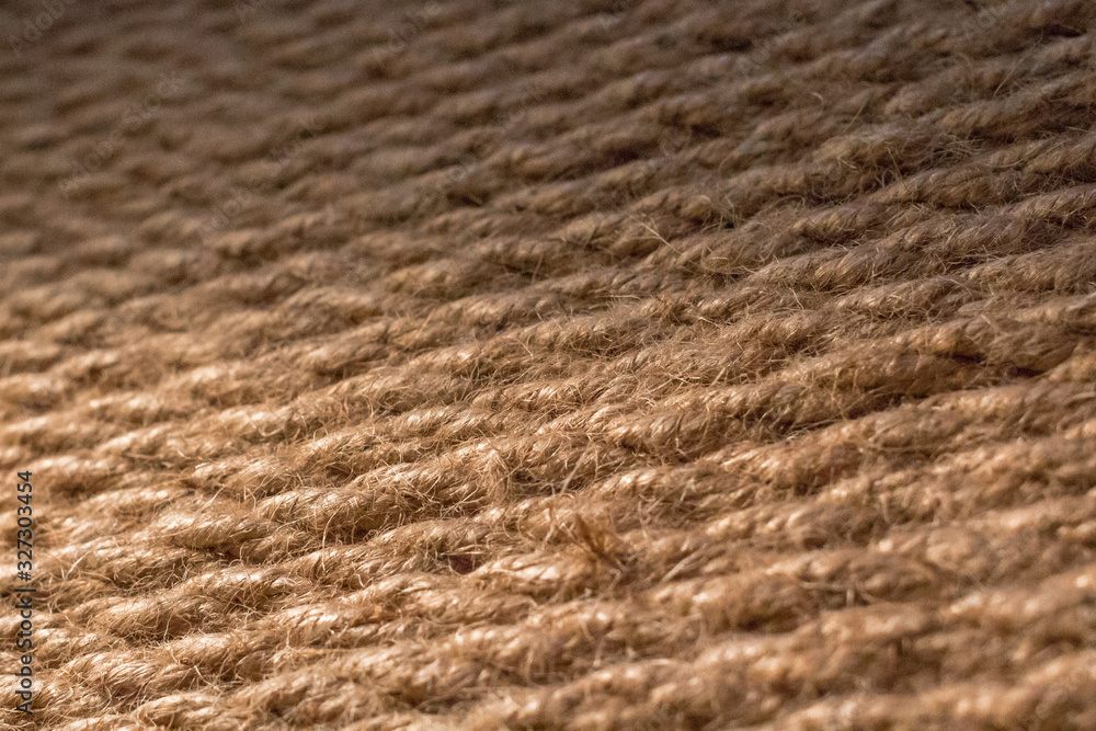 Thick rope. Rope in the interior decoration. Natural jute. Loft style element. Jute background. Coarse thread close-up. Coiled rope. Canvas for the point of cat's claws. Thick rope. Rope in the interior decoration. Natural jute. Loft style element. Jute background. Coarse thread close-up. Coiled rope. Canvas for the point of cat's claws.