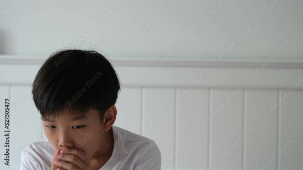 4k Young Asian boy get cough and take a mask to wear 4k Young Asian boy get cough and take a mask to wear