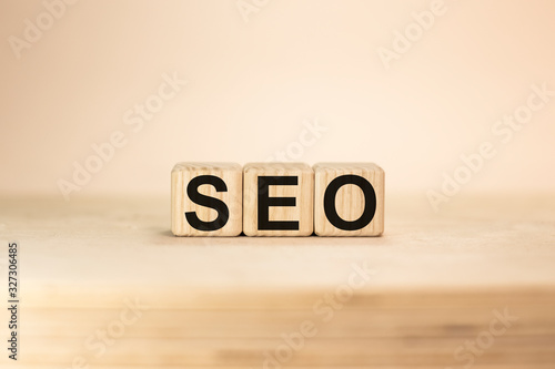 Seo word from wooden blocks on desk, search engine optimization concept