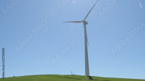 Big wind turbine of renewable energy moving with blue sky a sunny day photo