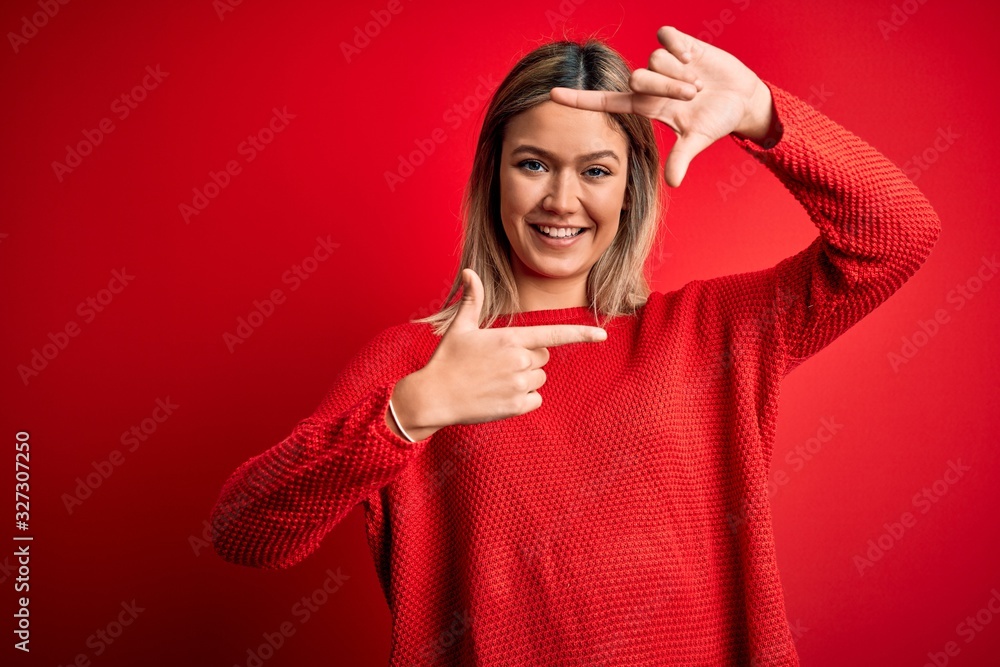 Young beautiful blonde woman wearing casual sweater over red isolated background smiling making frame with hands and fingers with happy face. Creativity and photography concept. Young beautiful blonde woman wearing casual sweater over red isolated background smiling making frame with hands and fingers with happy face. Creativity and photography concept.