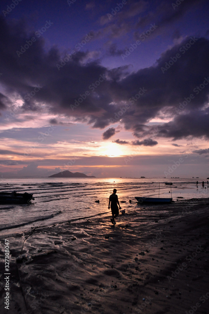 People walking on the beach under sunset People walking on the beach under sunset