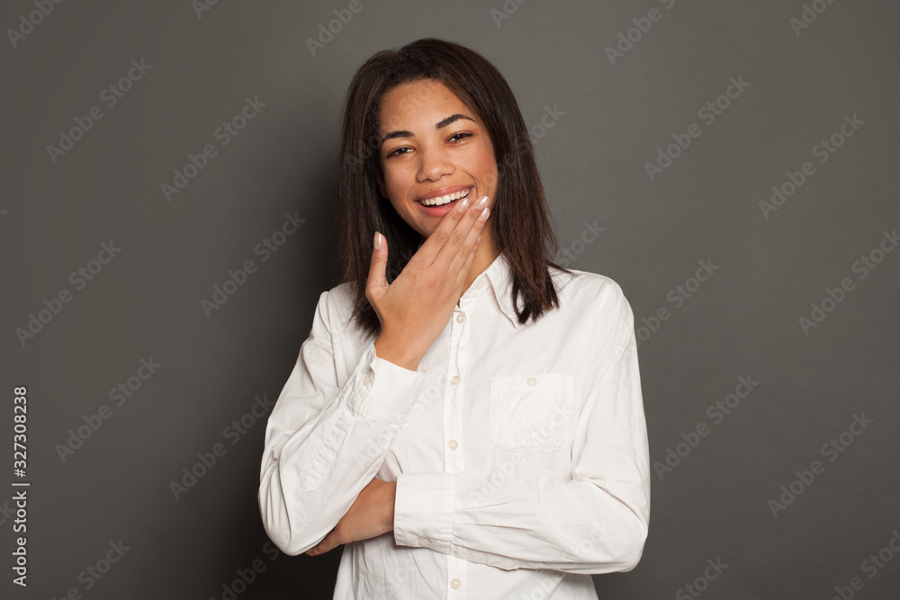 Laughing African American girl on gray background. Happy black woman portrait Laughing African American girl on gray background. Happy black woman portrait