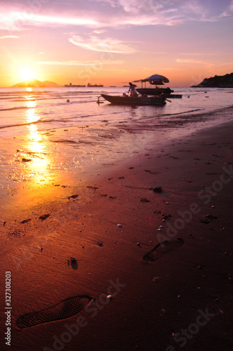 Footprints in the sand at sunset