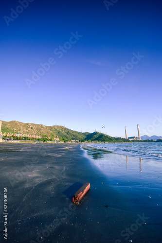 A wood on the beach under deep blue sky