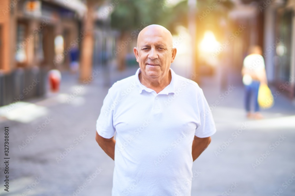 Senior handsome man smiling happy and confident. Standing with smile on face at town street Senior handsome man smiling happy and confident. Standing with smile on face at town street