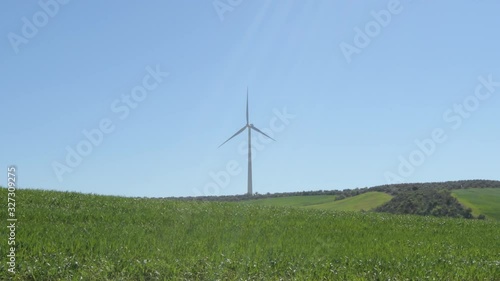 Landscape of wind turbine of renewable energy in the field moving with blue sky photo