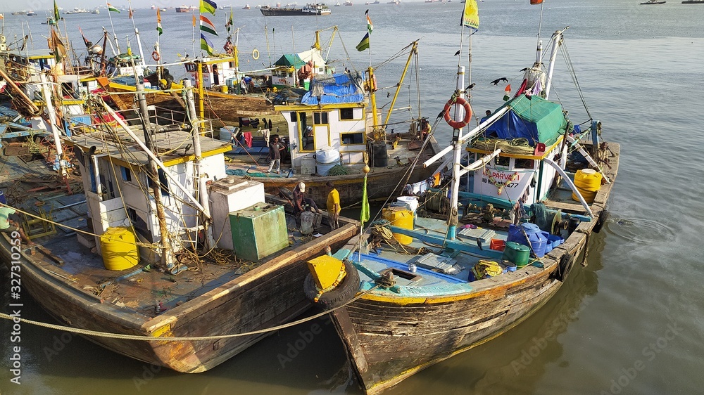 Mumbai, Maharastra/India- February 22 2020: Traditional fishing boats docked near the sea shore.