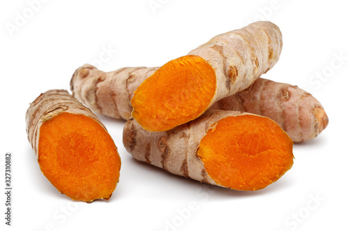 Fresh turmeric with slices isolated on white