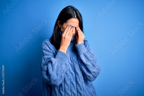 Young brunette woman with blue eyes wearing casual turtleneck sweater rubbing eyes for fatigue and headache, sleepy and tired expression. Vision problem