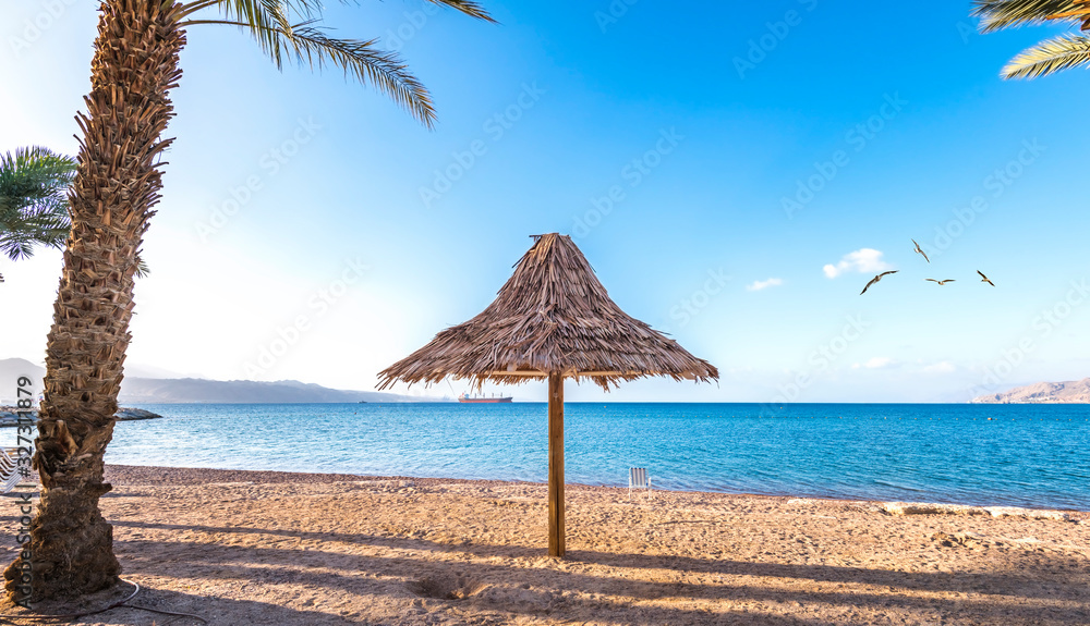 Morning and relaxing atmosphere at the central public beach of the Red Sea in Eilat - famous tourist resort and recreational city in Israel Morning and relaxing atmosphere at the central public beach of the Red Sea in Eilat - famous tourist resort and recreational city in Israel