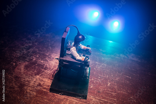 Death penalty electric chair miniature on dark. Creative artwork decoration. © zef art