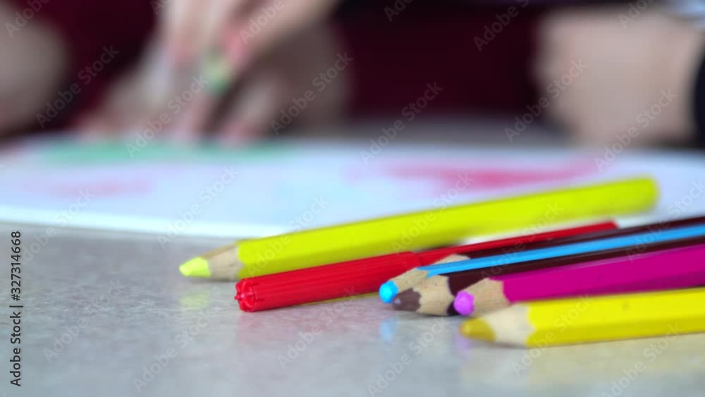 Mother and son drawing with crayons on a paper Mother and son drawing with crayons on a paper