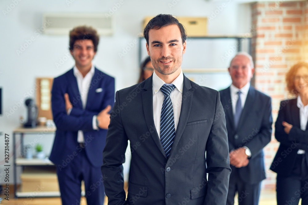 Group of business workers smiling happy and confident in a meeting. Standing with smile on face looking at camera at the office. Group of business workers smiling happy and confident in a meeting. Standing with smile on face looking at camera at the office.