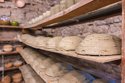 Fotografie Raw soaked clay lies on a shelf in a row