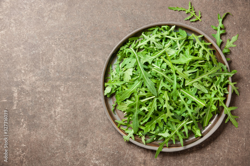 Fresh rucola leaves on ceramic plate