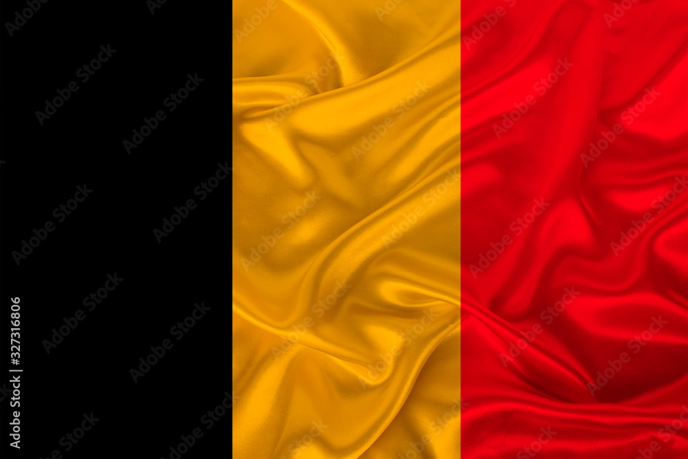 photo of the national flag of Belgium on a luxurious texture of satin, silk with waves, folds and highlights, close-up, copy space, travel concept, economy and state policy, illustration