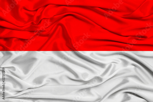 beautiful photo of the national flag of Monaco and Indonesia on delicate shiny silk with soft draperies, the concept of state power, country life, horizontal, close-up, copy space
