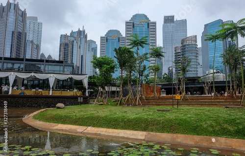 Jakarta, Indonesia - February 29th 2020: Jakarta Business District taken from an outdoor garden photo