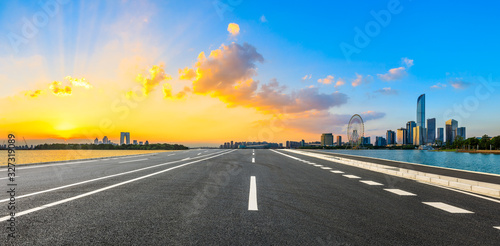 Empty asphalt road and beautiful city skyline with buildings at sunset in Suzhou,panoramic view.