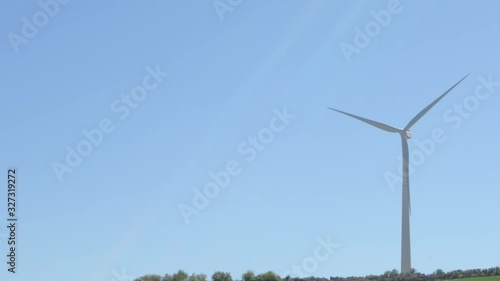 Wind turbine of renewable energy moving the blades with blue sky a sunny day photo