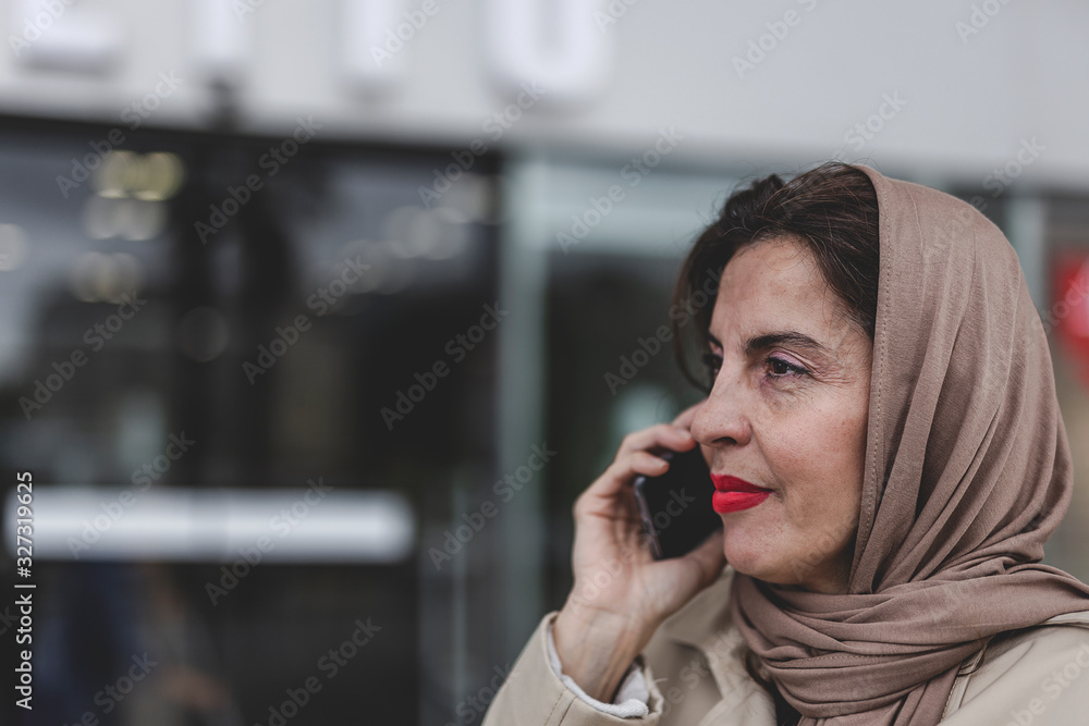 Arab woman with hijab talking on the phone Arab woman with hijab talking on the phone