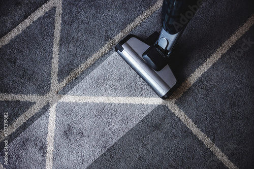 Close up of steam cleaner cleaning very dirty carpet. photo