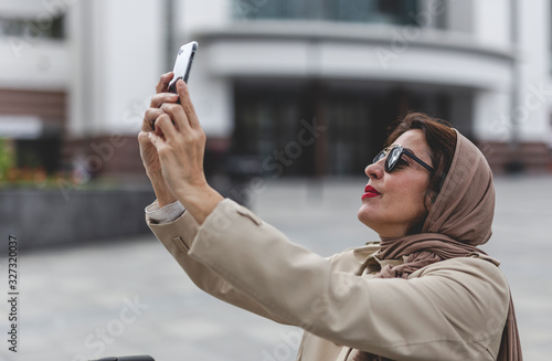 Attractive Arab woman with hijab taking a selfie