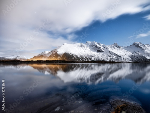 Mountains and night sky, Lofoten islands, Norway. Reflection on the water surface. Winter landscape with night sky. Long exposure shot. Norway travel - image