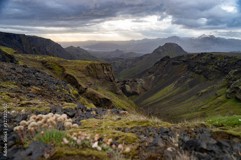 Fototapeta premium Canyon and Mountain peak during dramatic and colorful sunset on the Fimmvorduhals Hiking trail near Thorsmork