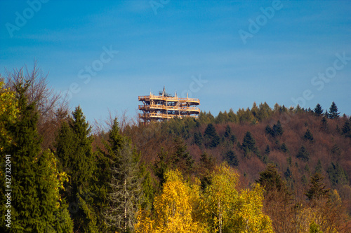 Treetop observation tower in resort town Krynica-Zdroj in autumn. View from Jaworzyna Krynicka Mountain.