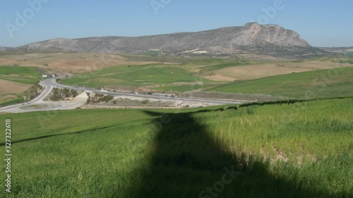 Shadow of wind turbine of renewable energy moving in the field photo