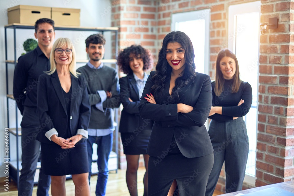 Fototapeta premium Group of business workers smiling happy and confident. Posing together with smile on face looking at the camera, young beautiful woman with crossed arms at the office