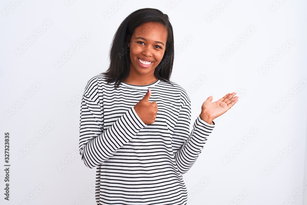 Beautiful young african american woman wearing winter sweater over isolated background Showing palm hand and doing ok gesture with thumbs up, smiling happy and cheerful Beautiful young african american woman wearing winter sweater over isolated background Showing palm hand and doing ok gesture with thumbs up, smiling happy and cheerful