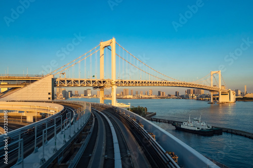 Japan. Railway tracks and rainbow bridge in Tokyo. Transport system of the capital of Japan. Rainbow bridge on the background of Odaiba island. Artificial Islands in Tokyo. Guide to Japan.