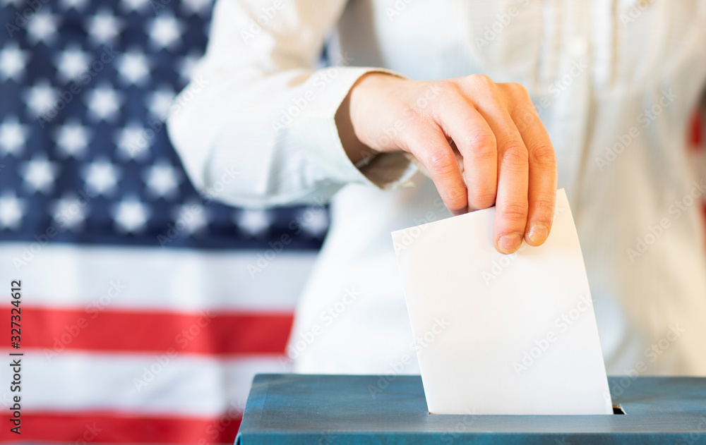 usa elections the hand of woman putting her vote in the ballot box usa elections the hand of woman putting her vote in the ballot box