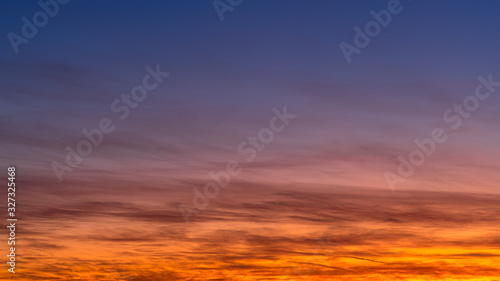 Sunset sky with colored clouds. Abstract background © MKozloff