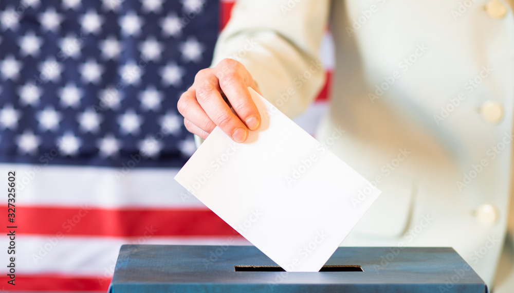 usa elections the hand of woman putting her vote in the ballot box usa elections the hand of woman putting her vote in the ballot box