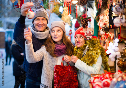 mature married couple with a teenage daughter at Christmas market