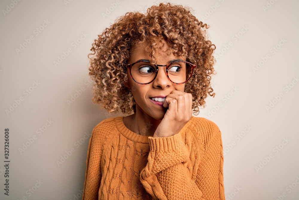 Young african american woman wearing casual sweater and glasses over white background looking stressed and nervous with hands on mouth biting nails. Anxiety problem. Young african american woman wearing casual sweater and glasses over white background looking stressed and nervous with hands on mouth biting nails. Anxiety problem.