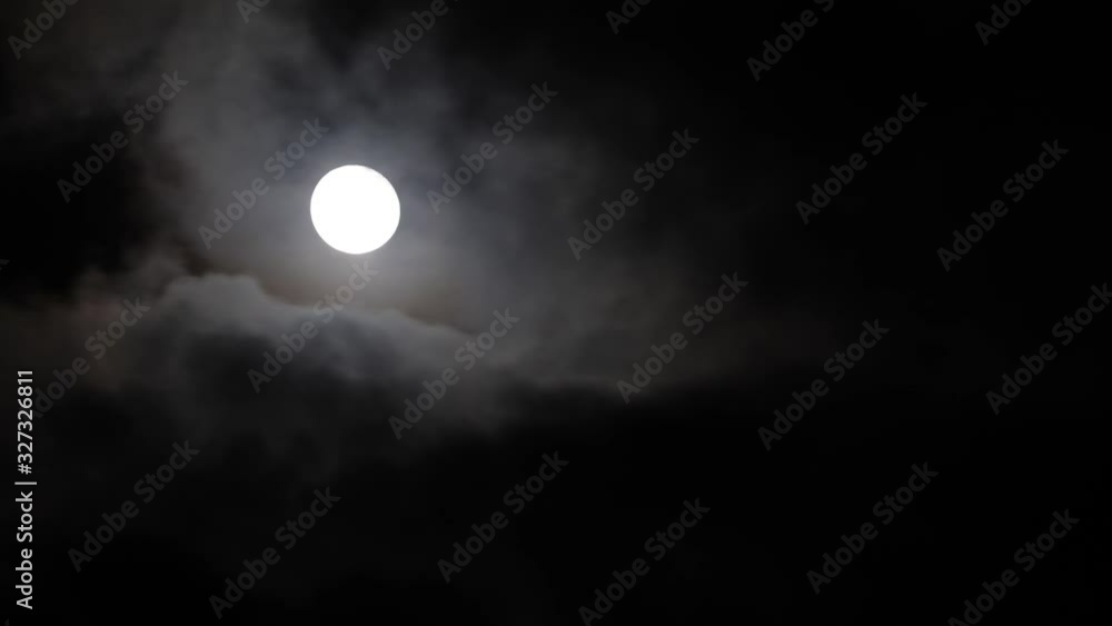 Timelapse of full moon hiding behind clouds Timelapse of full moon hiding behind clouds