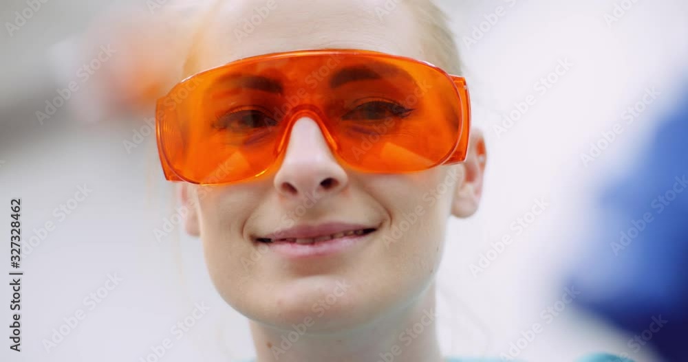 dentist using UV hardener during surgey at healthcare clinic dentist using UV hardener during surgey at healthcare clinic