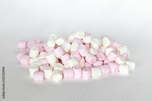 Pink and white mini marshmallows on white background  sweet food