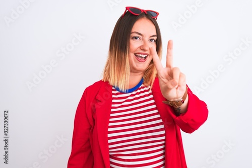 Young beautiful woman wearing striped t-shirt and jacket over isolated white background smiling looking to the camera showing fingers doing victory sign. Number two.