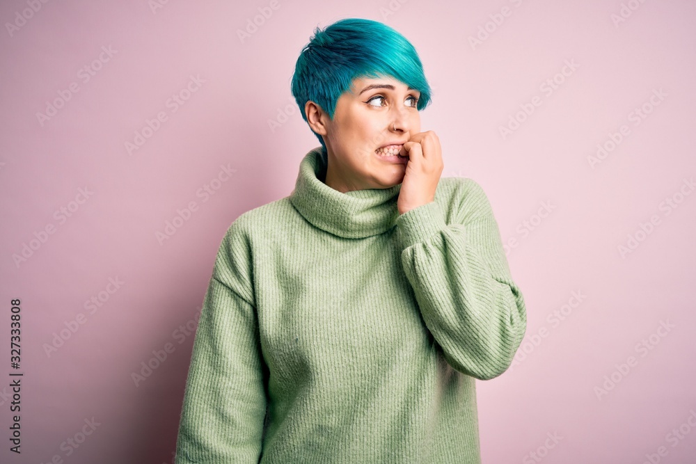 Young beautiful woman with blue fashion hair wearing casual turtleneck sweater looking stressed and nervous with hands on mouth biting nails. Anxiety problem. Young beautiful woman with blue fashion hair wearing casual turtleneck sweater looking stressed and nervous with hands on mouth biting nails. Anxiety problem.
