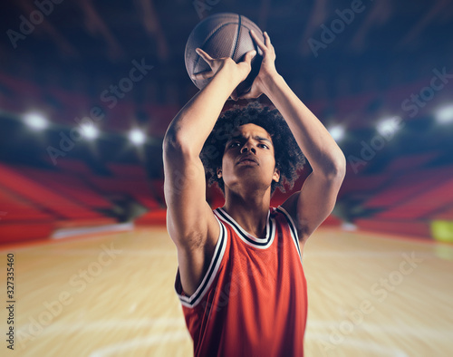 Young African American boy with basketball taking a free throw © alphaspirit
