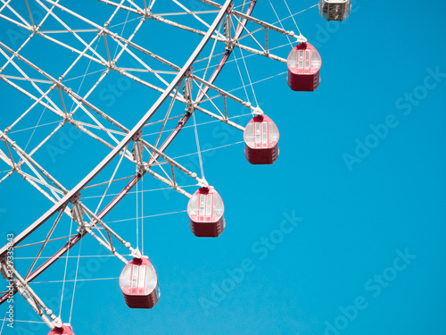 Ferris Wheel Over Blue Sky Background
