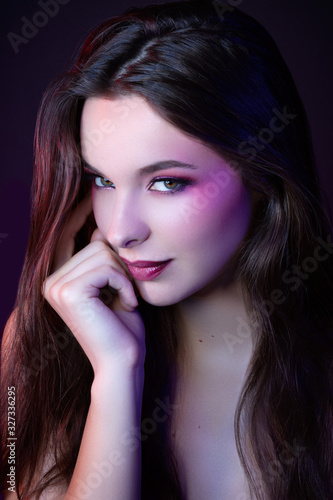 Colorful portrait of a pretty sensual young woman looking towards the camera